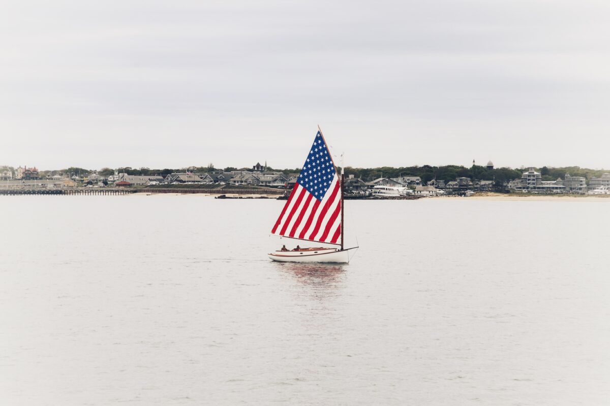 sailboat with American flag themed sail approaching Martha's Vineyard