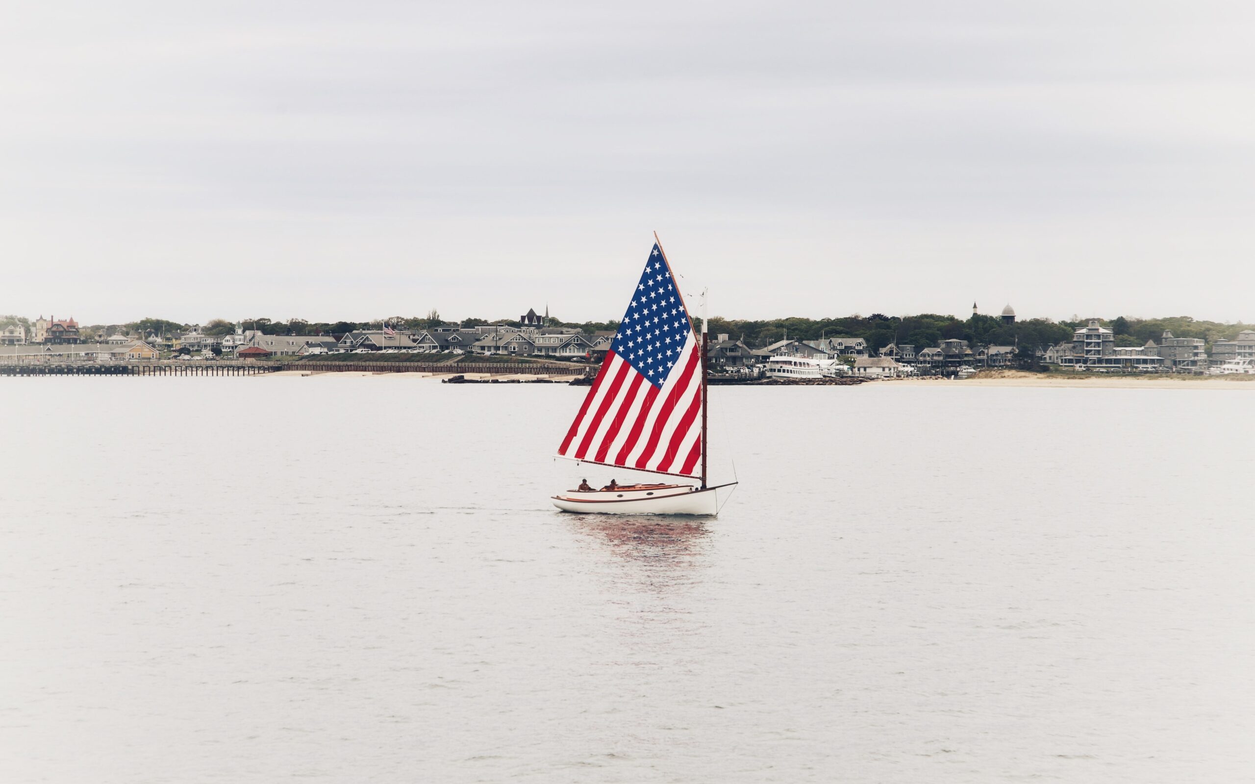 sailboat with American flag themed sail approaching Martha's Vineyard