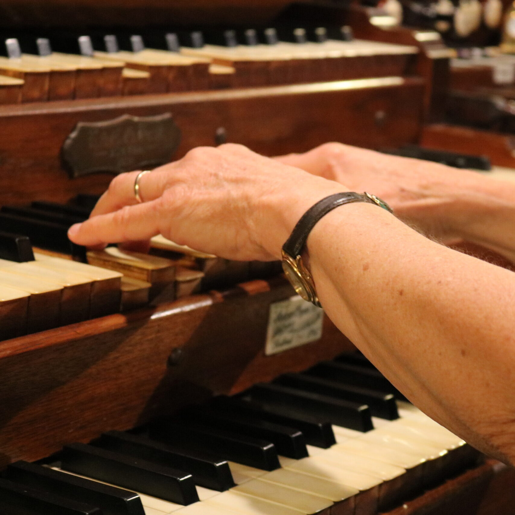 hands on the organ keyboard
