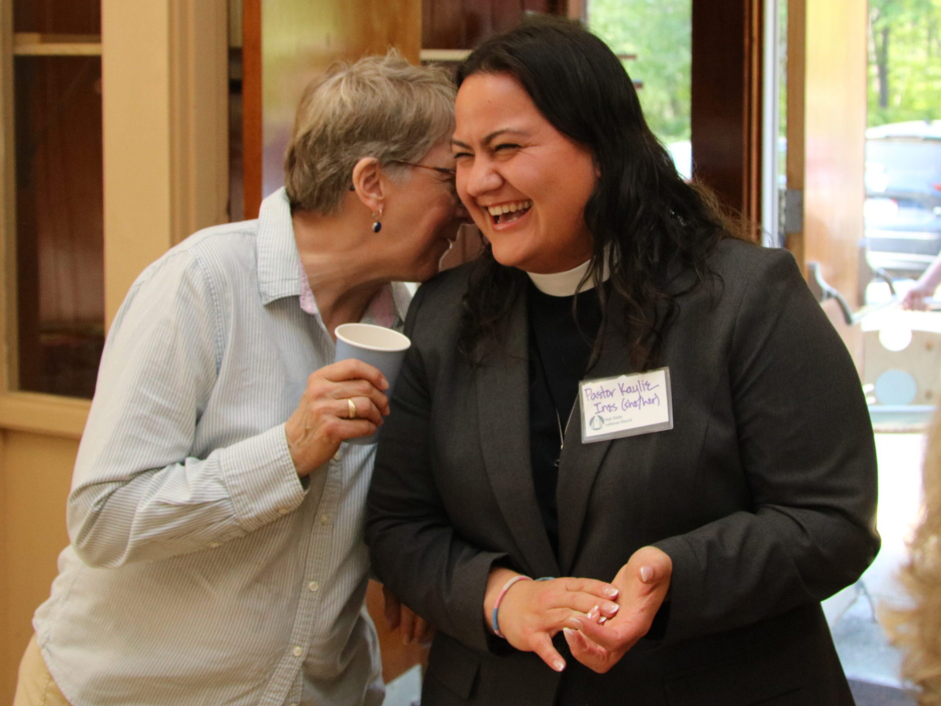 Pastor Kaylie shares a laugh with an HTLC parishioner during the pre-call social event on May 16.