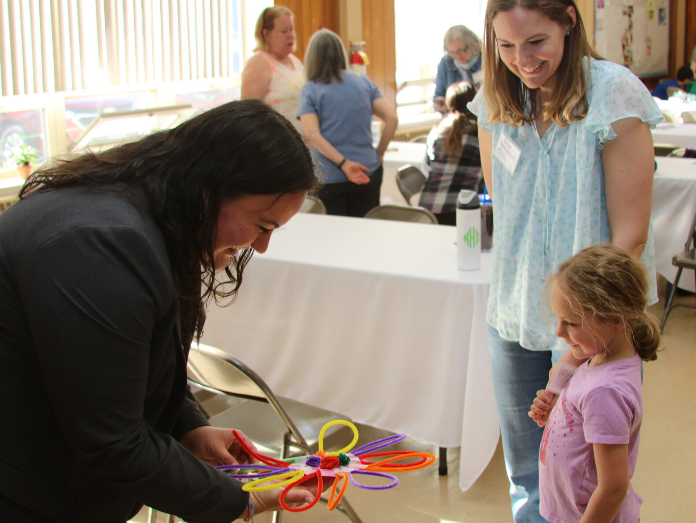 Rev. Ines accepts a flower from a young member of Holy Trinity during the pre-call social event on May 16.